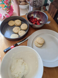 Kids helping to make the strawberry shortcake dough.