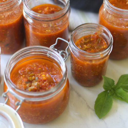 Jars of freezer marinara sauce made from garden tomatoes.