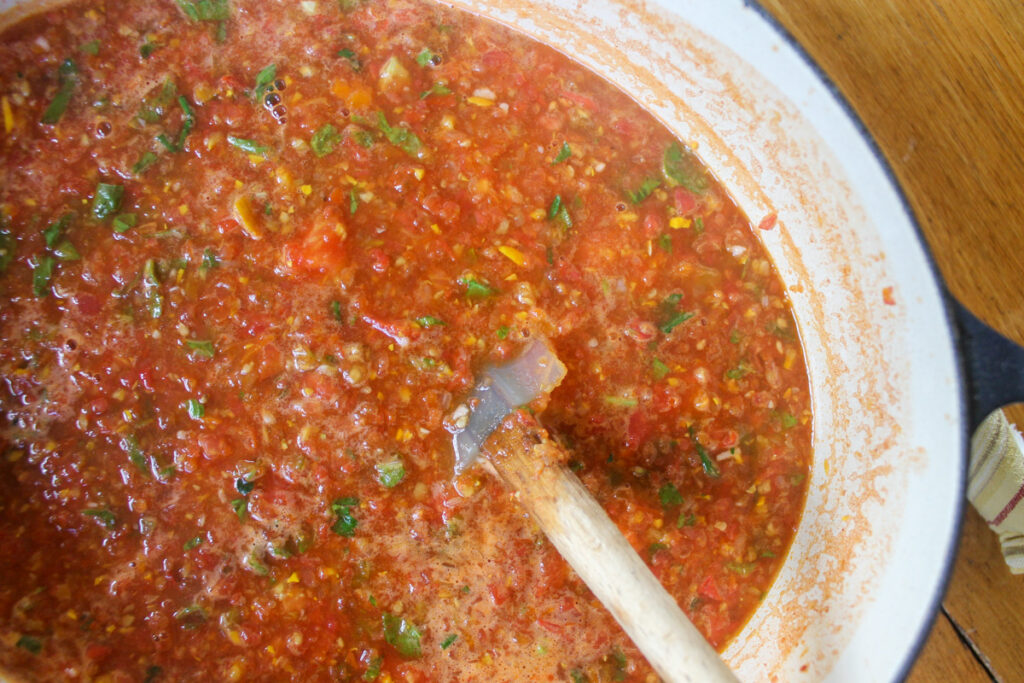 Large pot of homemade marinara sauce ready to be simmered and reduced.