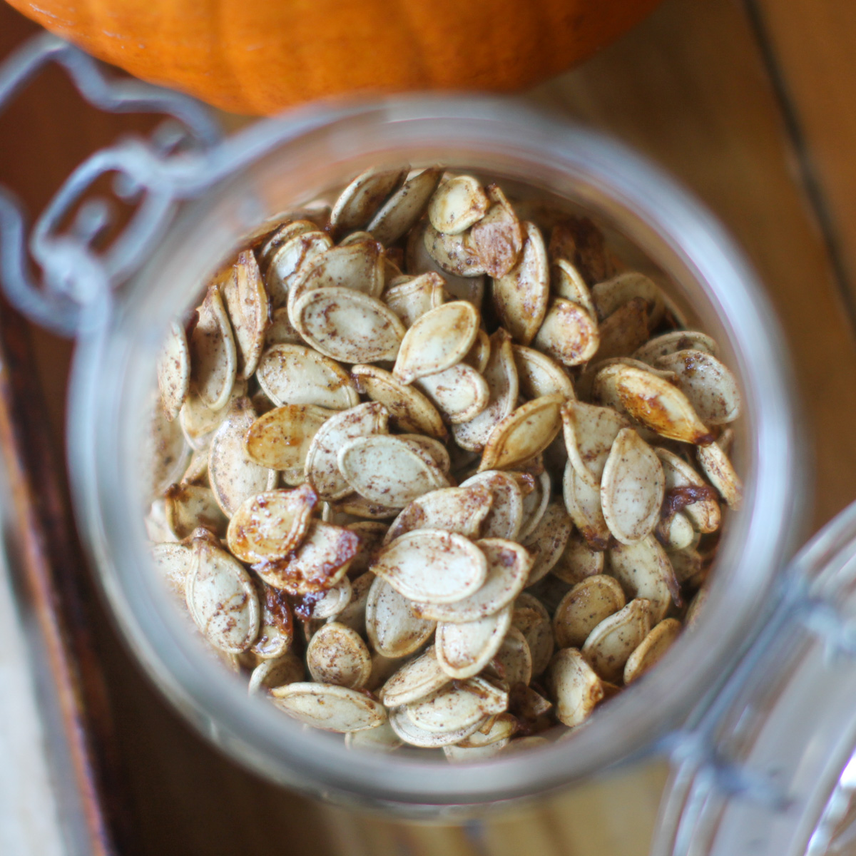 Looking down into a jar of sweet and salty roasted pumpkin seeds.