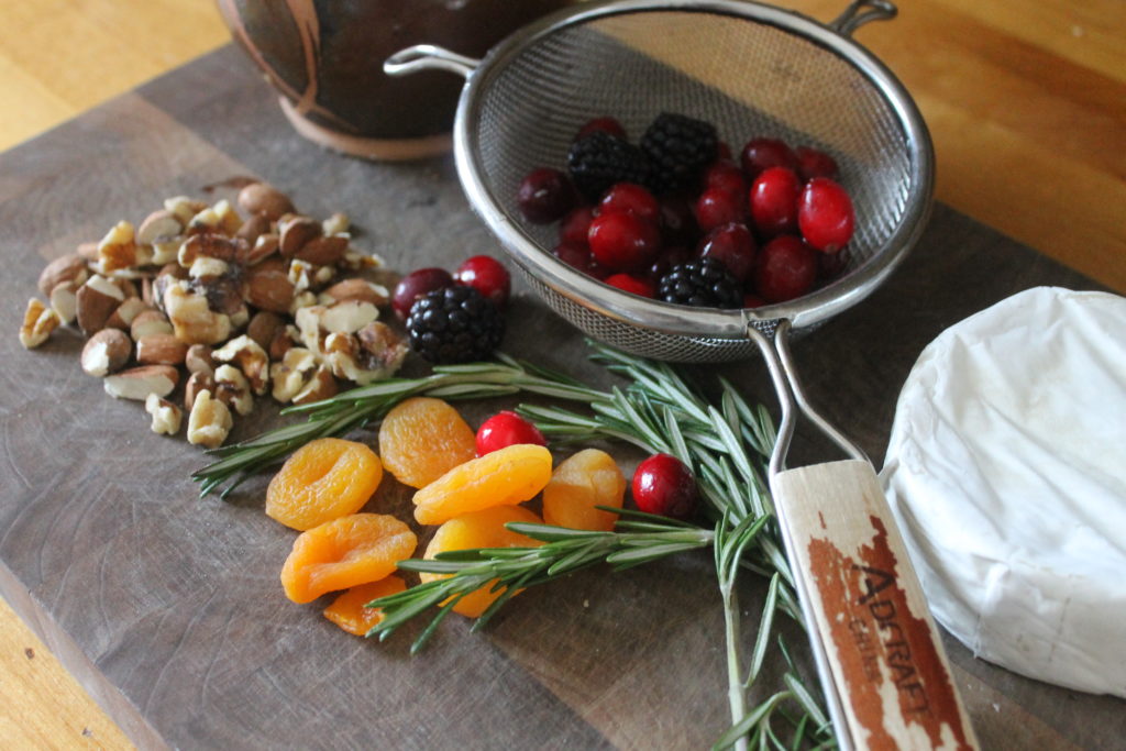 Ingredients on a cutting board for Cranberry Honey Baked Brie.