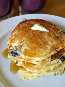 Protein Pancakes with blueberries, butter and maple syrup