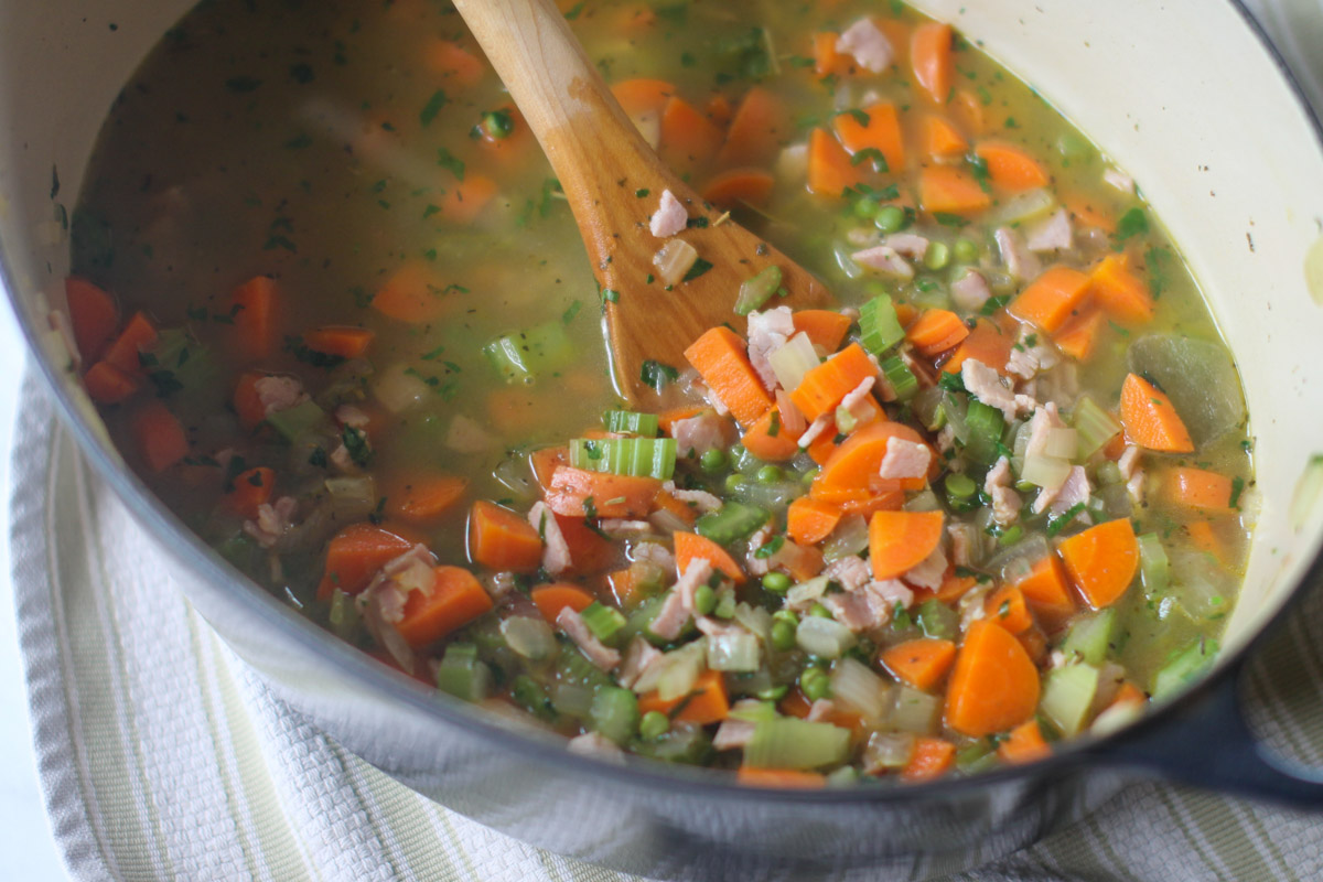 Split pea soup with all ingredients added and ready to start simmering to cook the split peas until creamy.