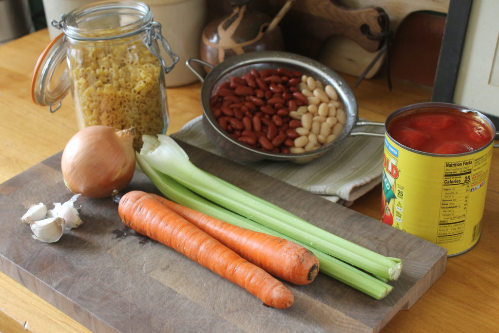 Pasta Fagioli Soup ingredients on a cutting board.