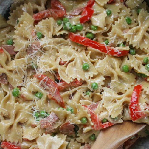 Creamy Farfalle Pasta with red bell peppers and peas.