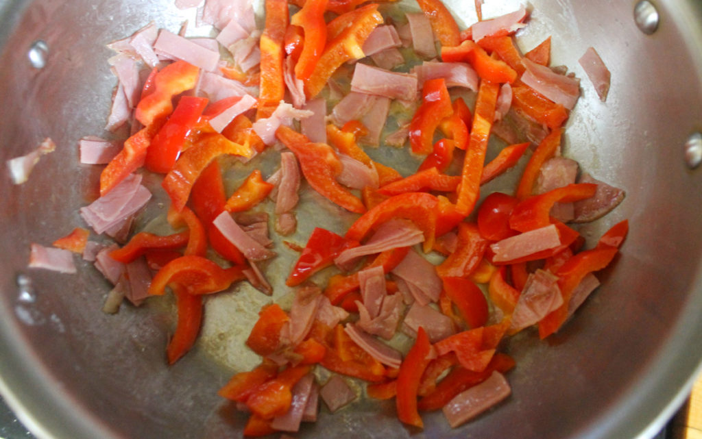 Cooking Peppers and Prosciutto in a skillet.