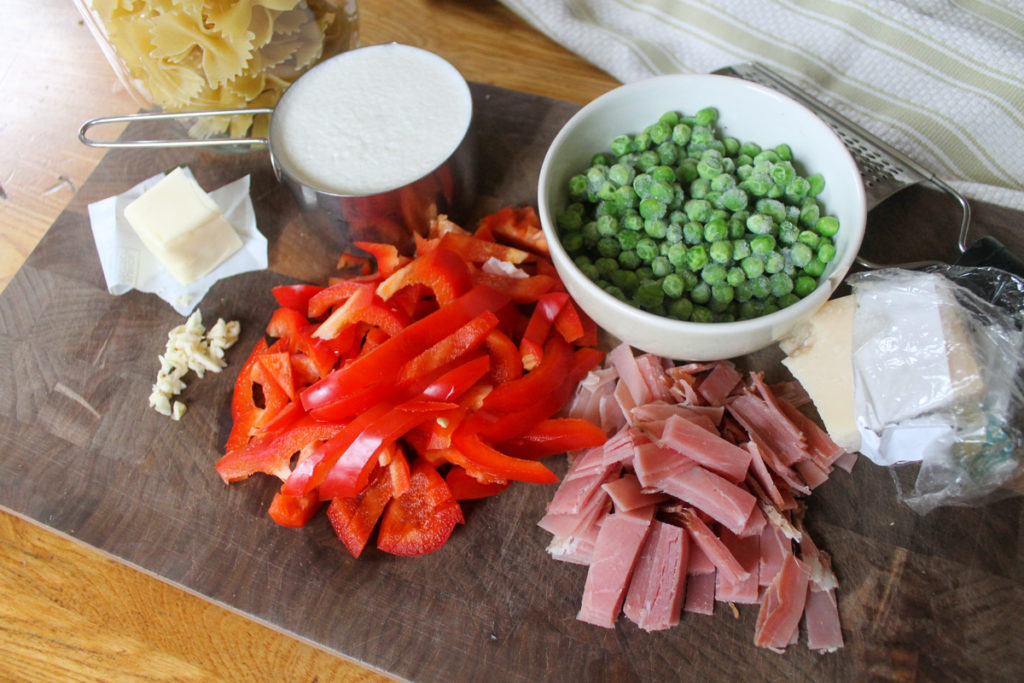 Creamy Farfalle Ingredients prepared on a cutting board.