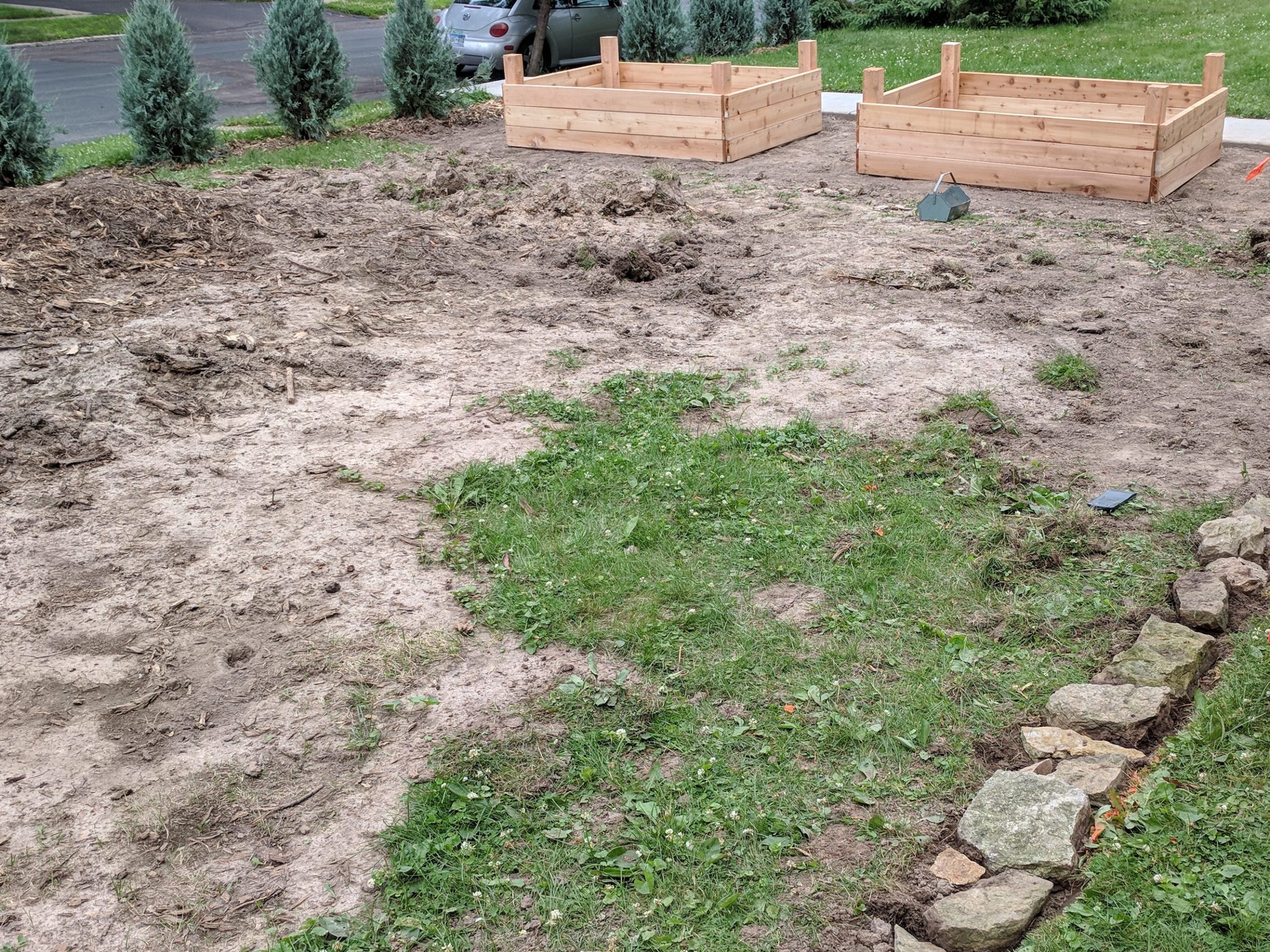 Process of building 8 raised vegetable garden beds.