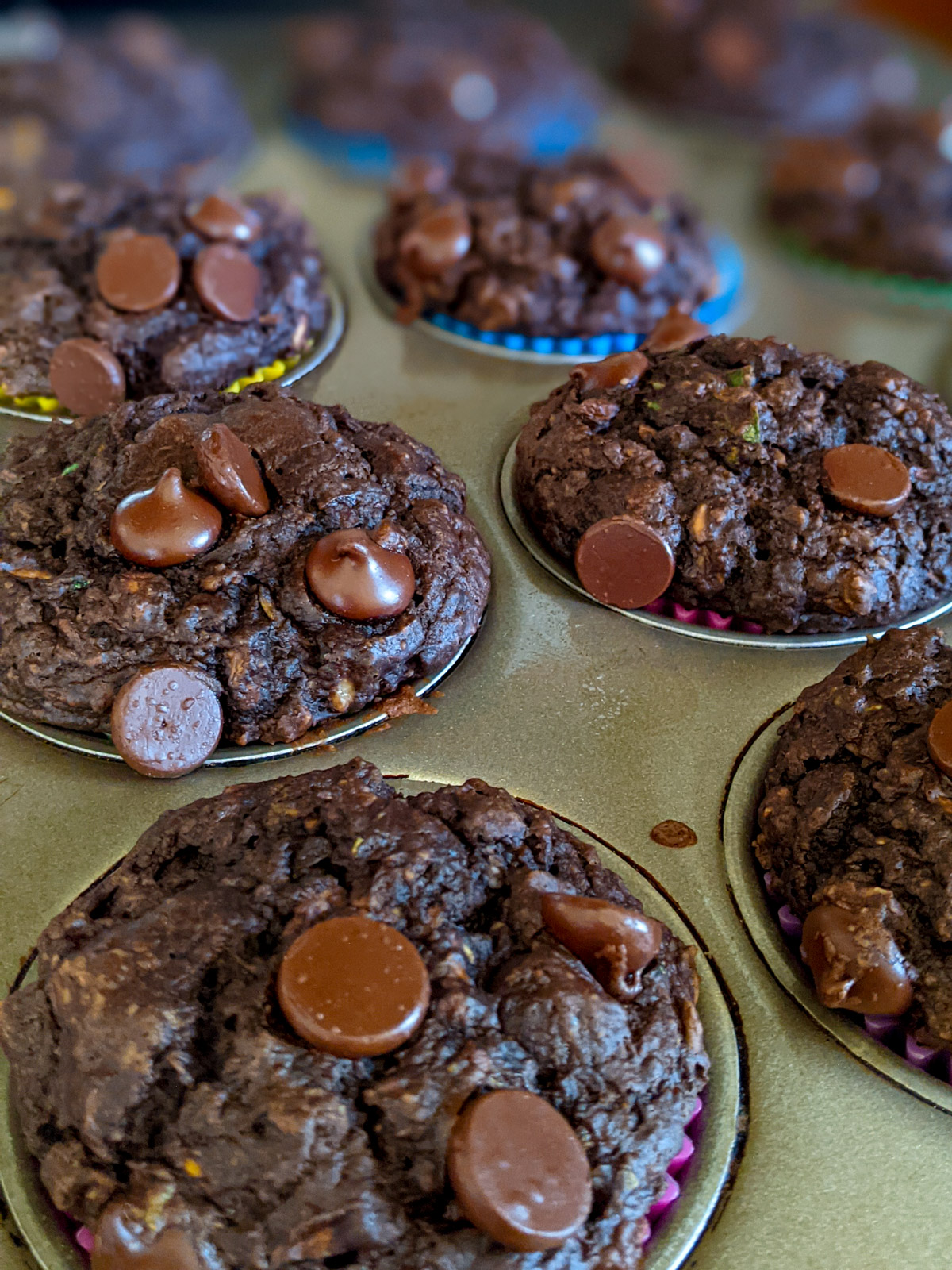 Chocolate Zucchini Muffins in a muffin tin.