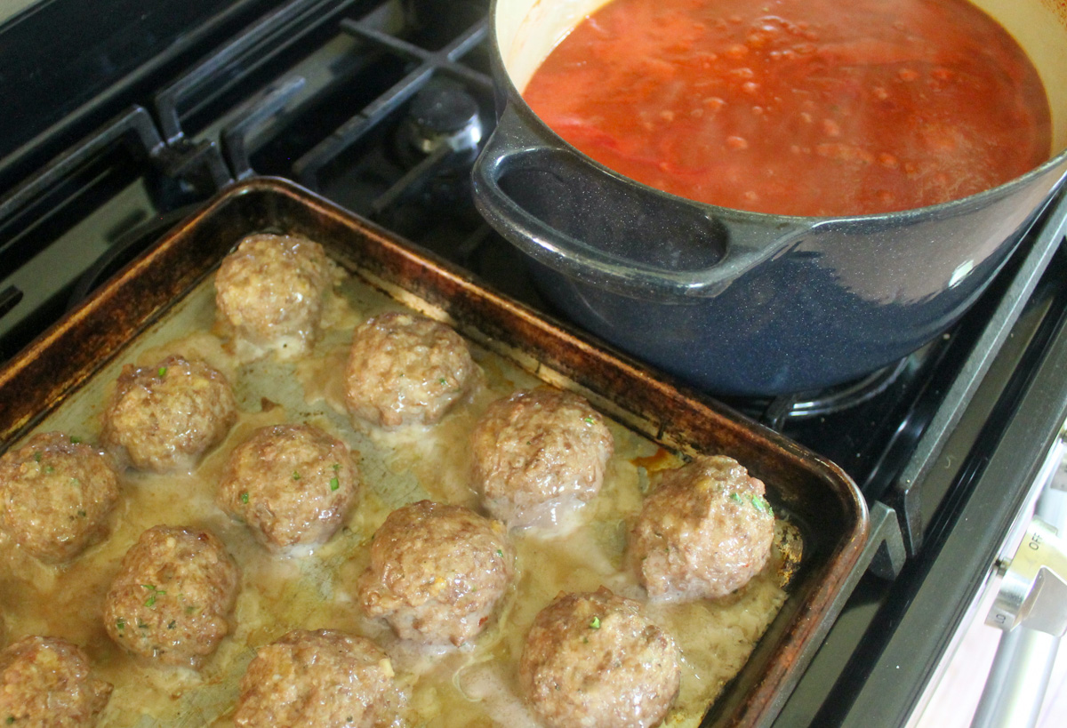 Italian sausage meatballs baked in the oven and ready to add to the tomato sauce.