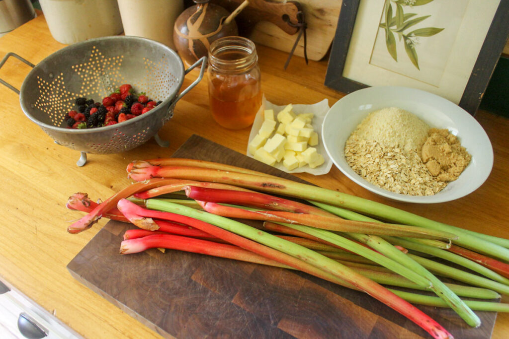 Healthy rhubarb crisp ingredients on a cutting board.