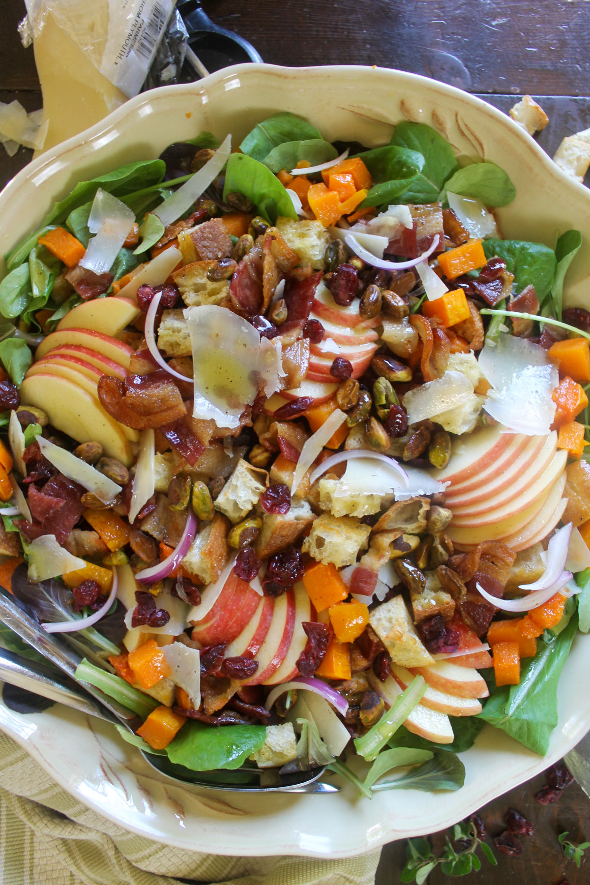 A large dish of the maple roasted butternut squash salad with dressing.