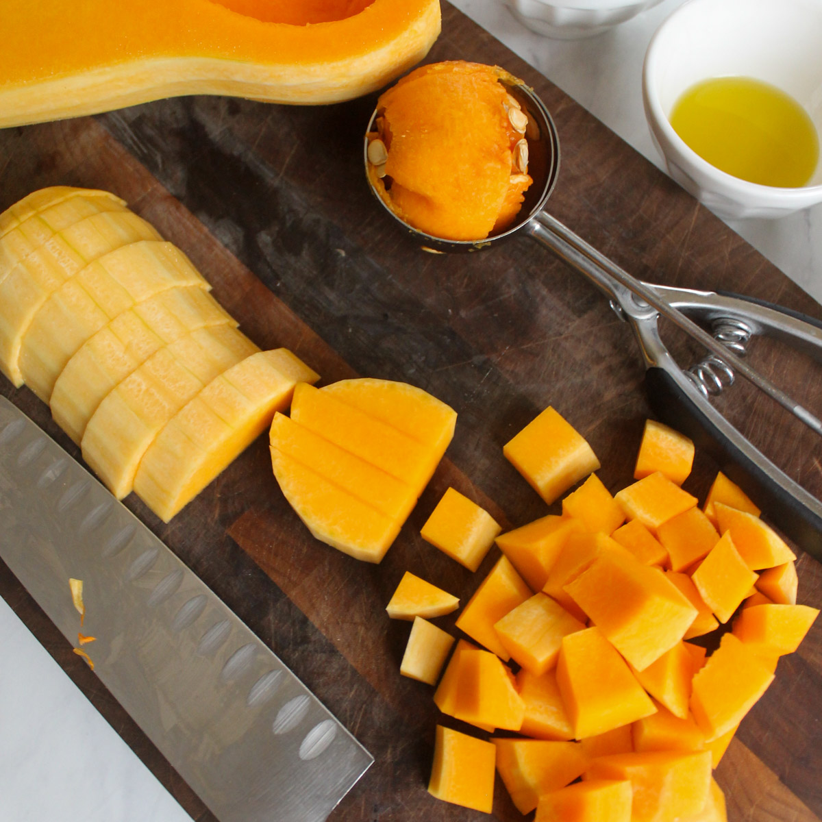 Chopping a butternut squash on a cutting board.