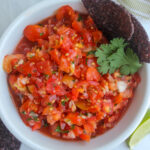 A top down shot of a bowl of food processor pico de gallo salsa.