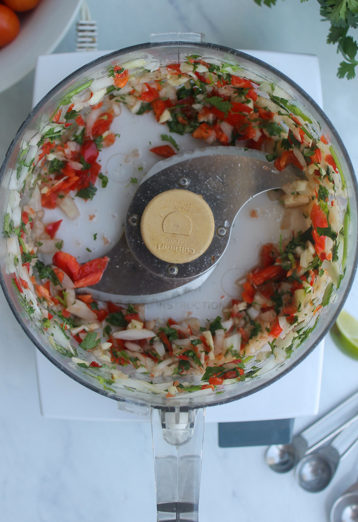 Veggies pulsed in the food processor before adding the tomatoes for freezer salsa.