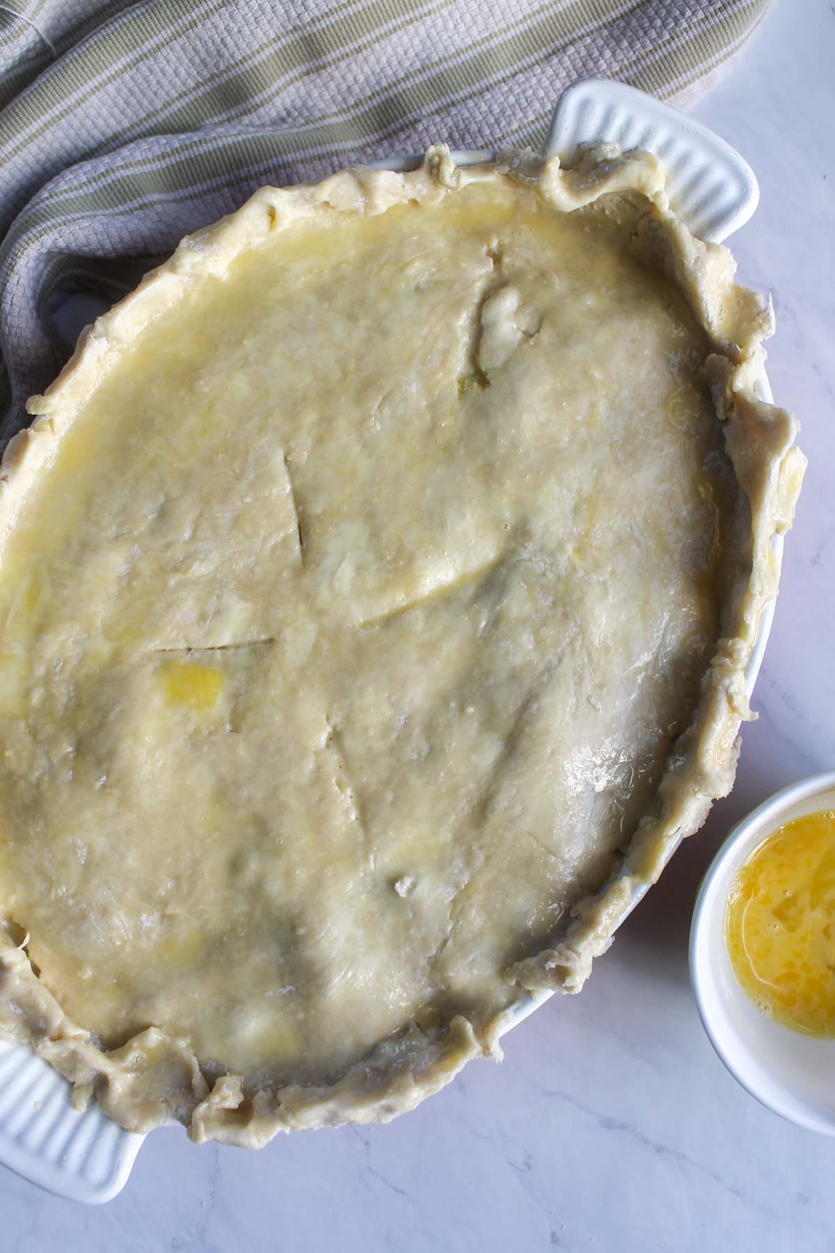 The chicken veggie pot pie brushed with egg wash and ready to bake.