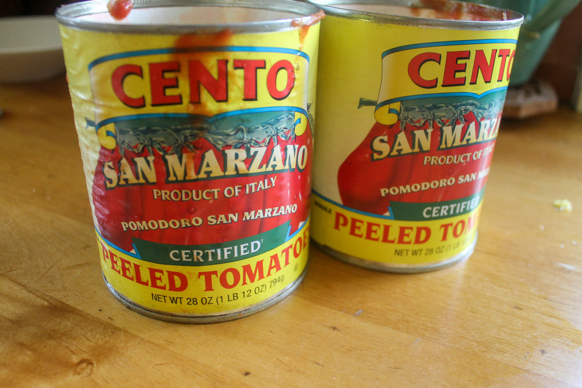 Two cans of Cento San Marzano Peeled Tomatoes used for White Bean Tomato Soup.