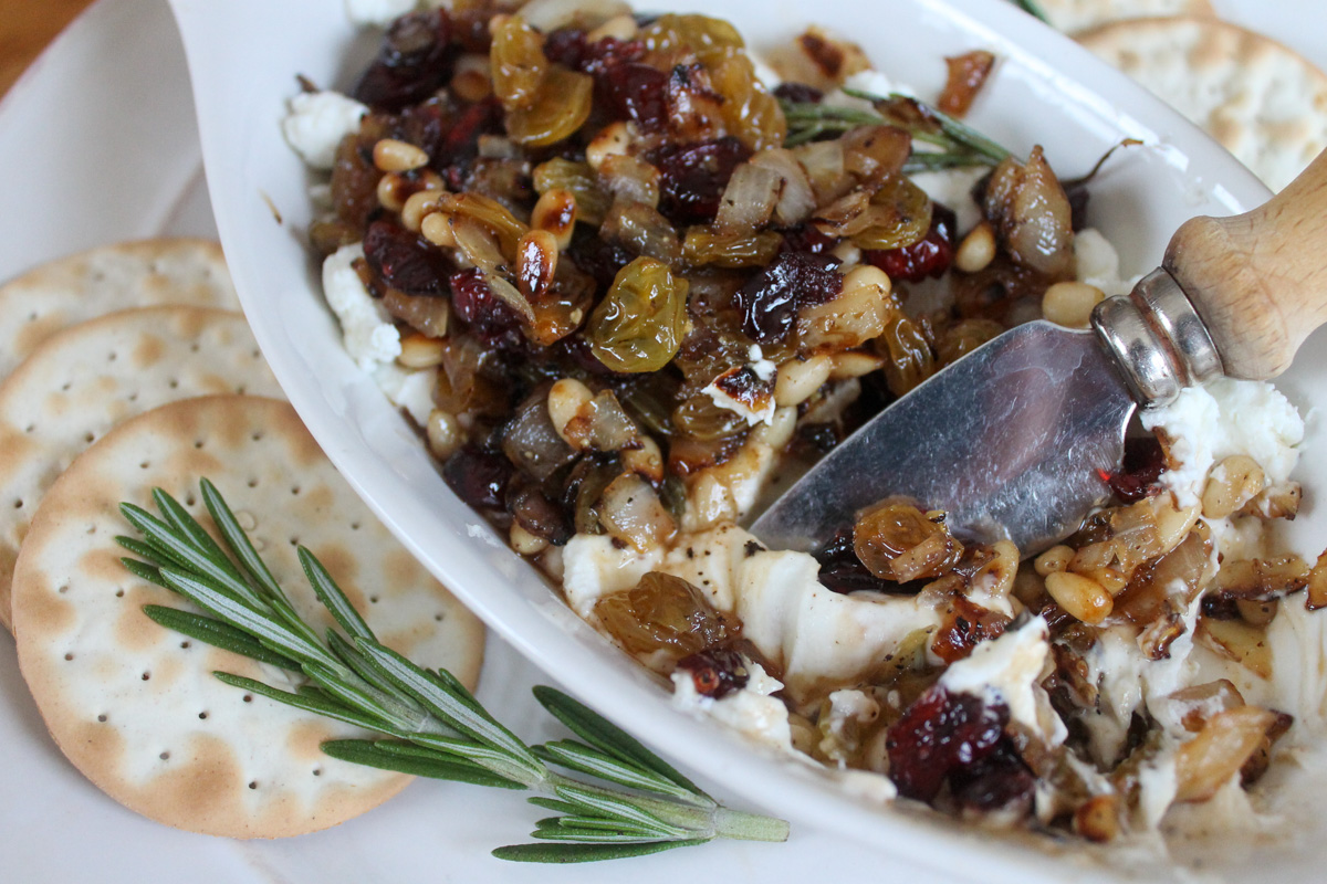 Goat cheese dip with raisin pine nut topping.