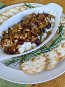 Goat cheese holiday appetizer with fresh rosemary sprigs.