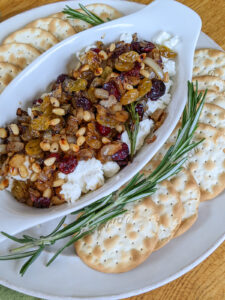 A dish of goat cheese appetizer with crackers.