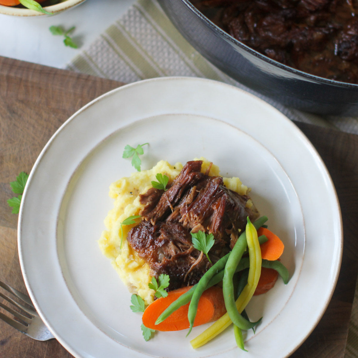 Dutch oven beef roast with potatoes and vegetables.