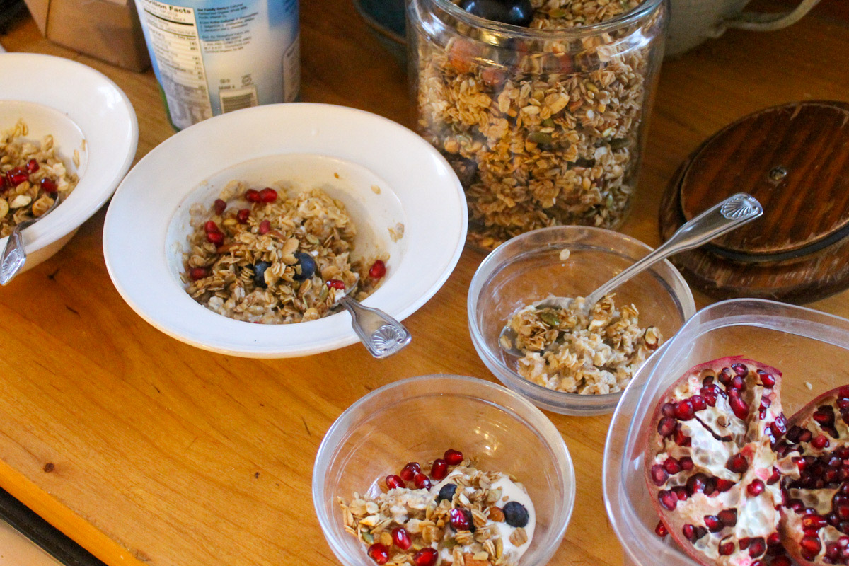Bowls of Granola with yogurt and berries on the counter.