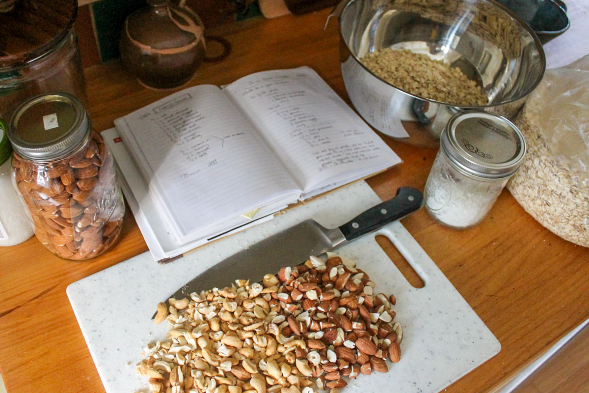 Chopped almonds and cashews on a cutting board for granola.