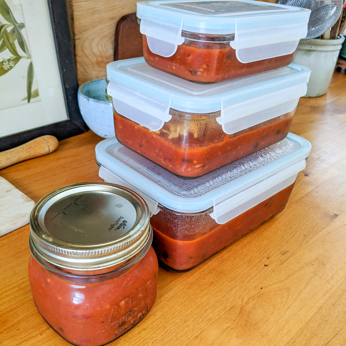 Different sized containers of leftover chili to refrigerate or freeze.