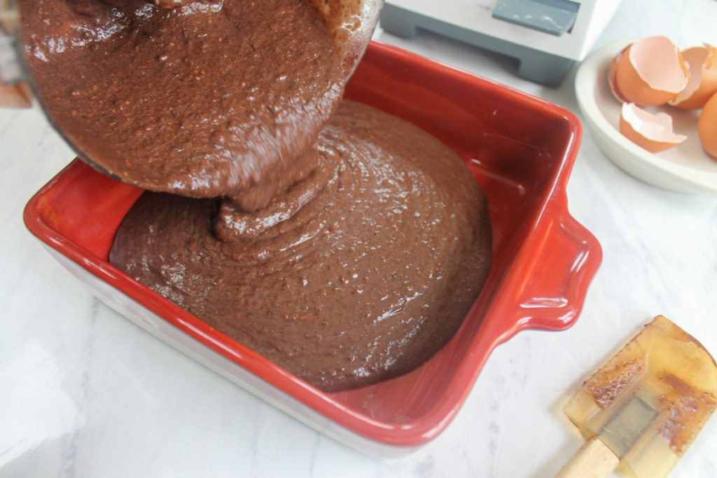 Protein Brownies pouring batter into baking dish
