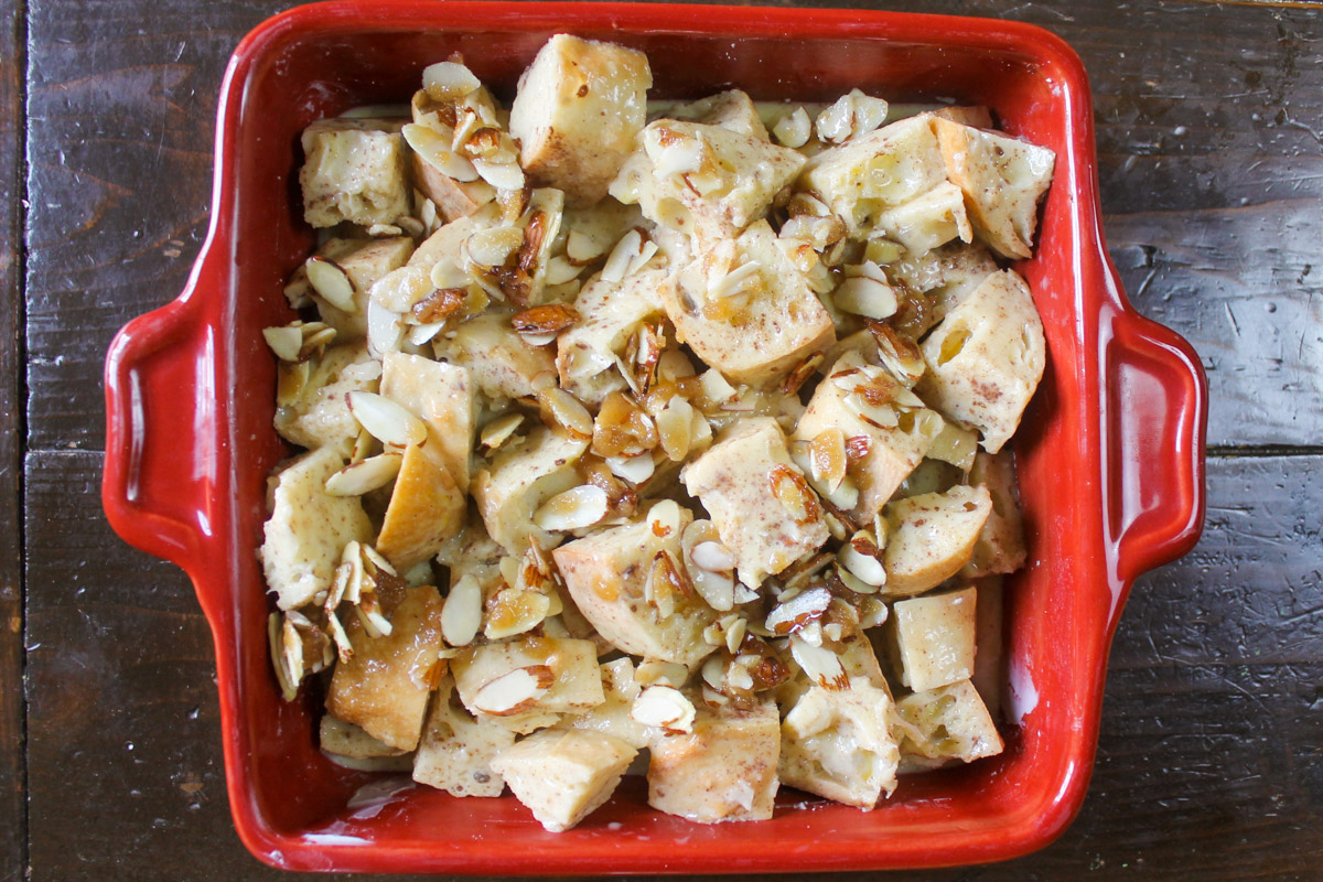 The bread and egg in a casserole dish with the almond topping ready to be refrigerated overnight.