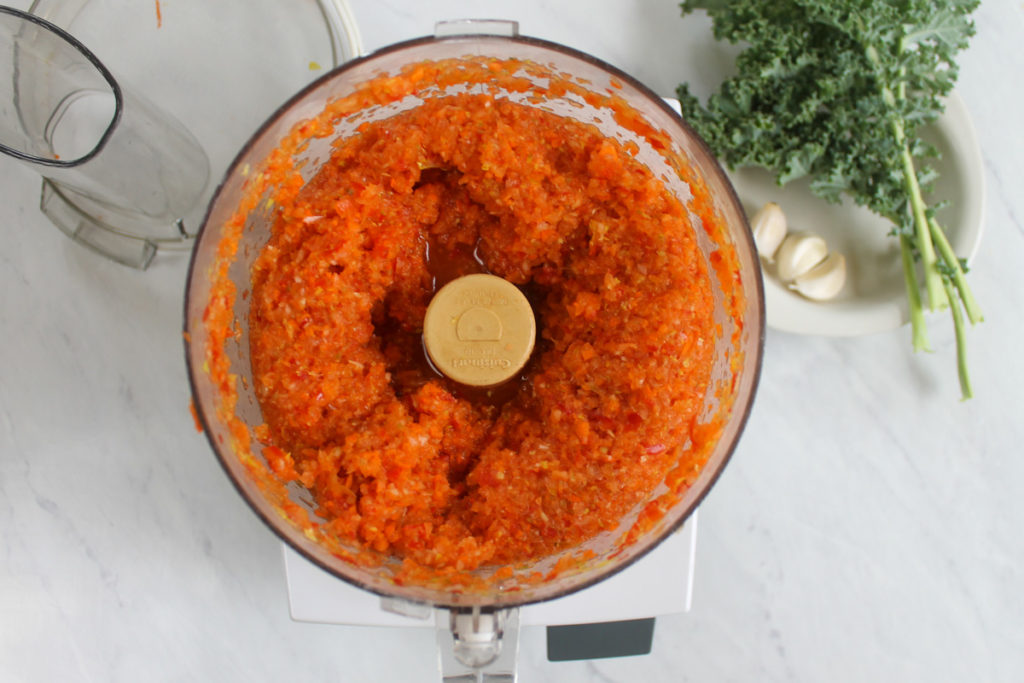 Pureed vegetables in food processor that will blend right in to bolognese sauce.