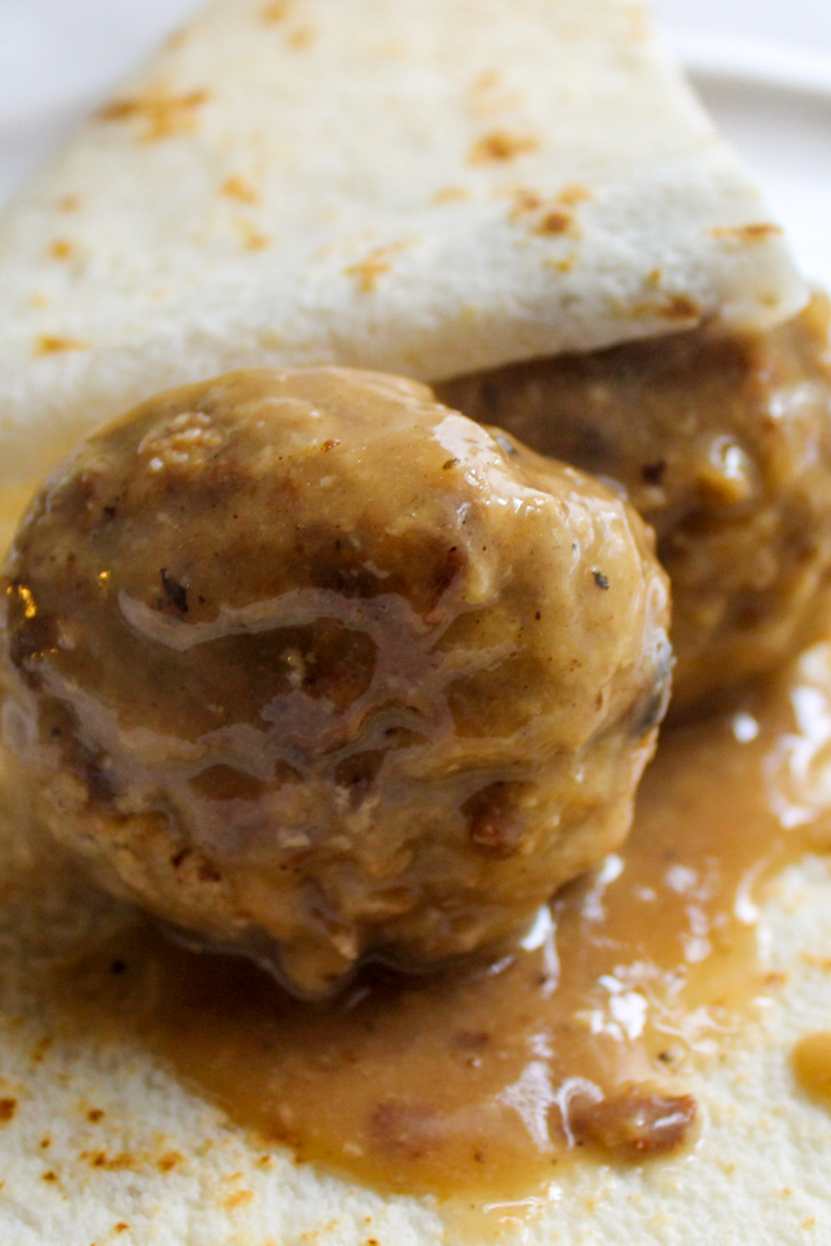 Meatballs in gravy wrapped in lefse.