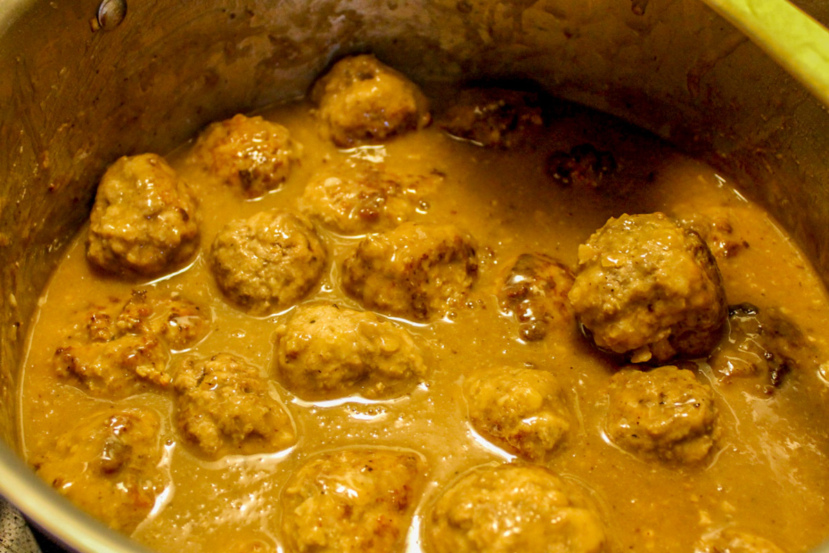 A pot of Norwegian Meatballs in brown gravy sauce. 