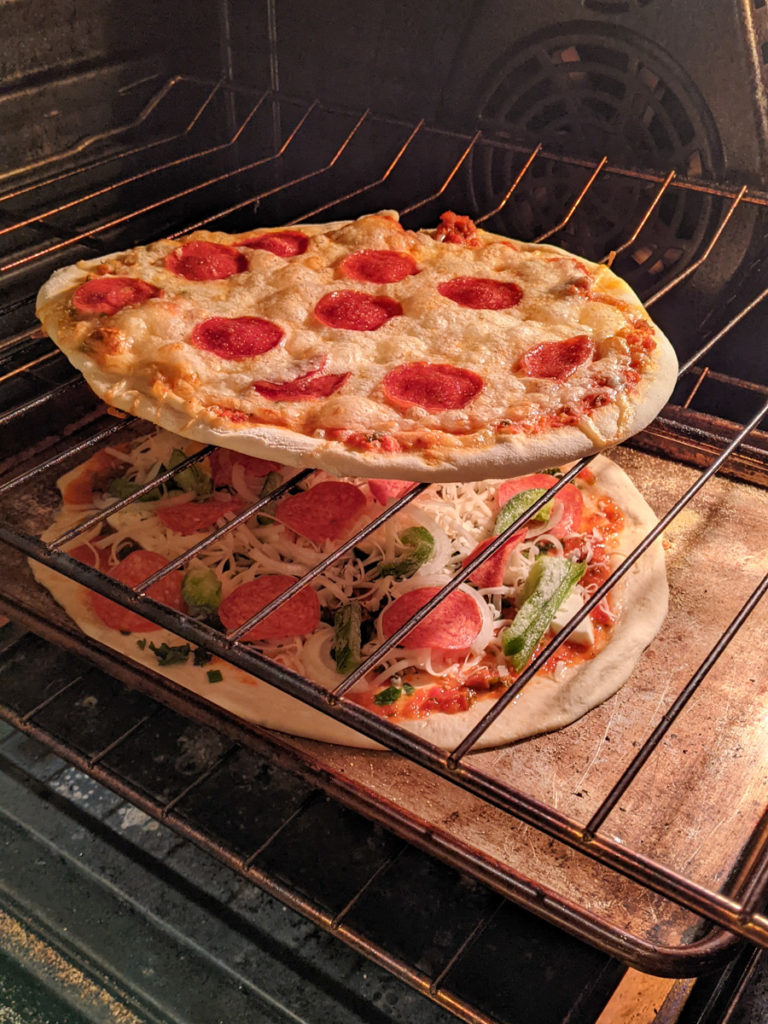 baking homemade pizza in the oven on a sheet pan