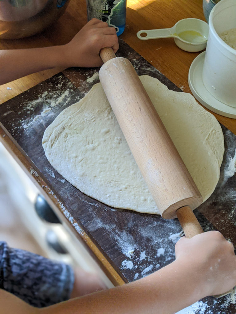 Rolling pizza dough process
