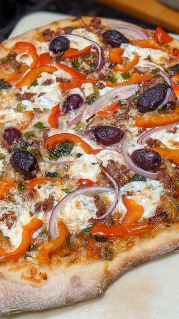 Pizza from the oven at home with peppers, onions and olives