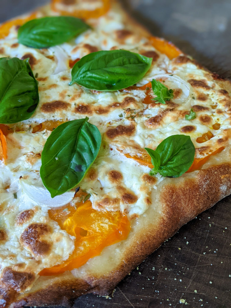 Homemade Pizza with tomato, cheese and basil