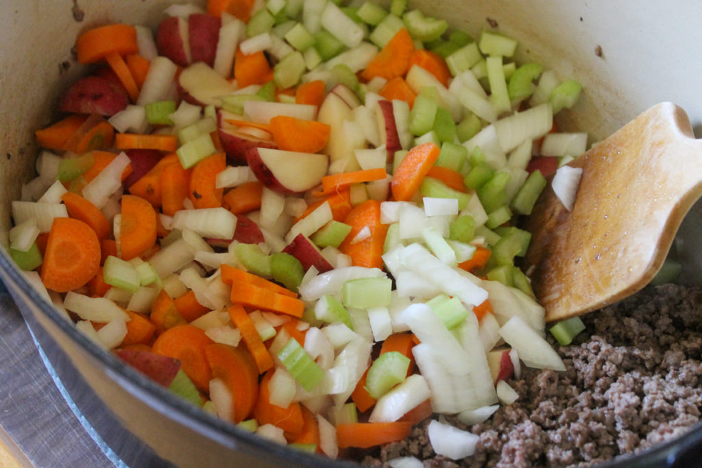 Sauteeing veggies and ground beef for soup.