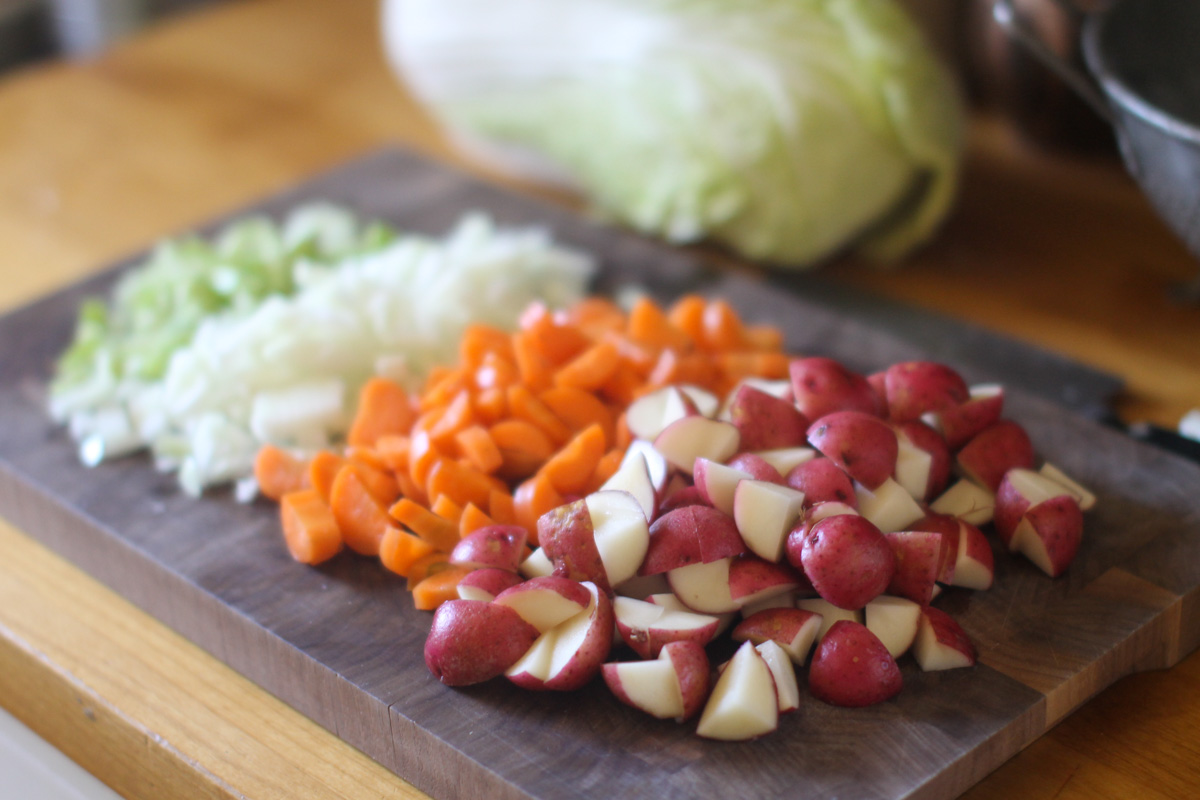Chopped Vegetables on a cutting board, celery, onion, carrot and potatoes for Beef Cabbage Soup.
