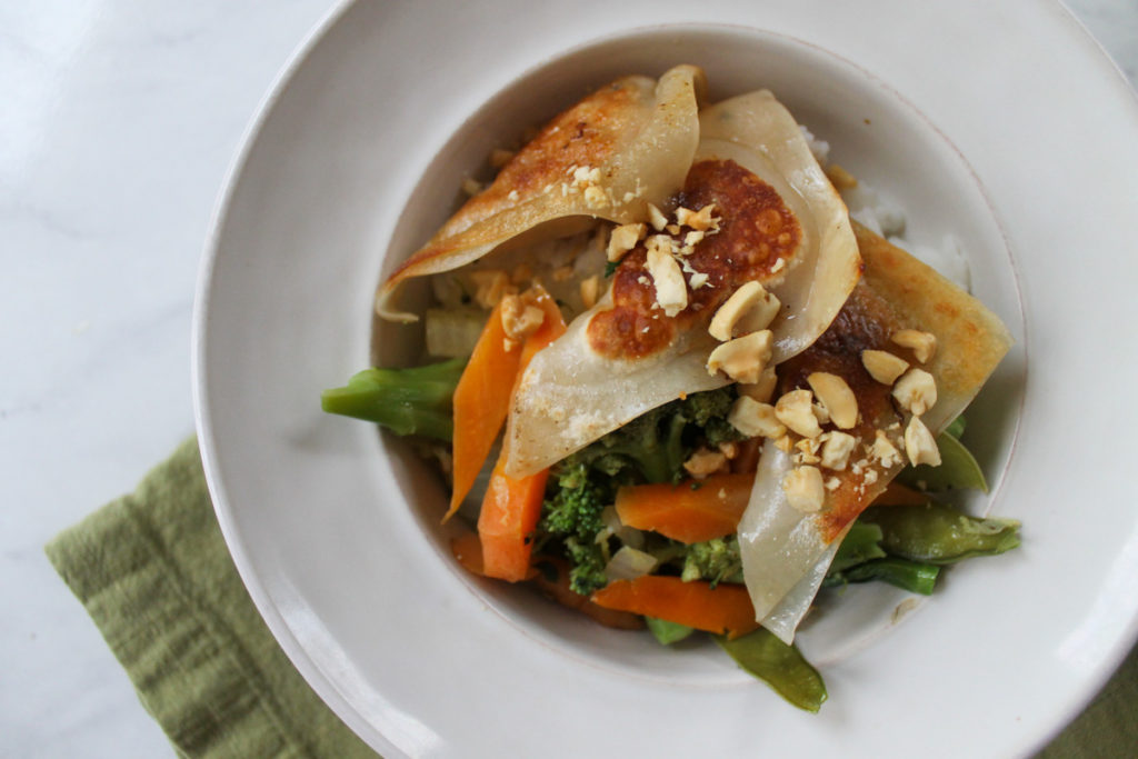 Homemade frozen potstickers cooked with veggies and rice.