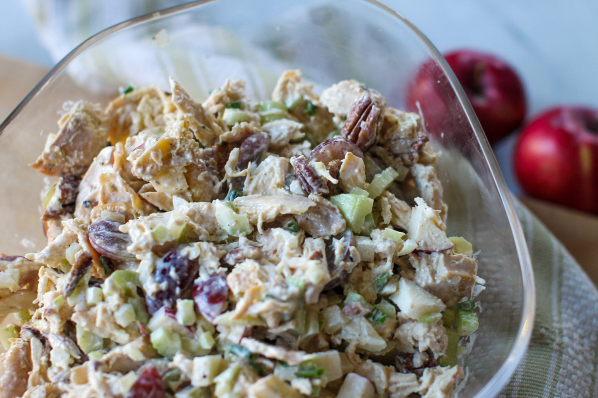 Chicken Salad with Grapes and Apples mixed together with mayo in a bowl.