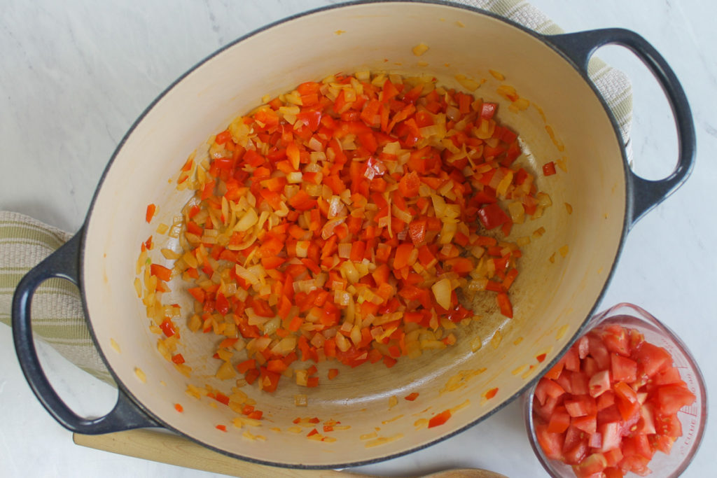Sautéing onions and red bell pepper for chicken tortilla soup.