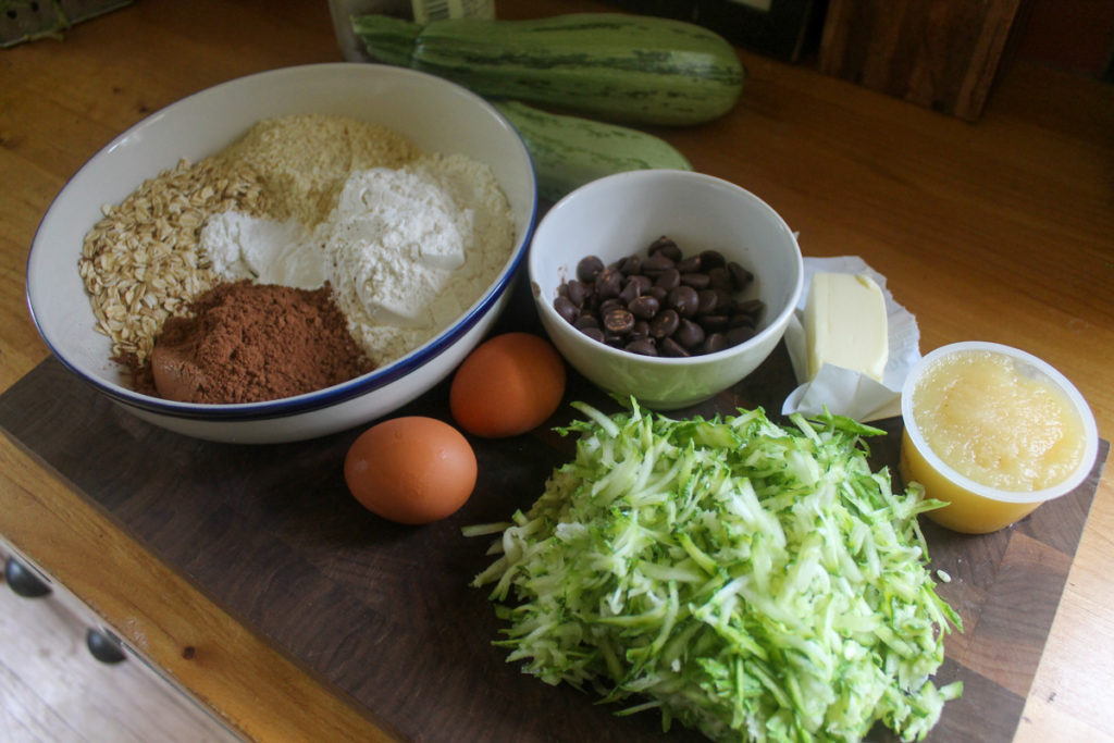 Double Chocolate Zucchini Muffin ingredients on a cutting board.