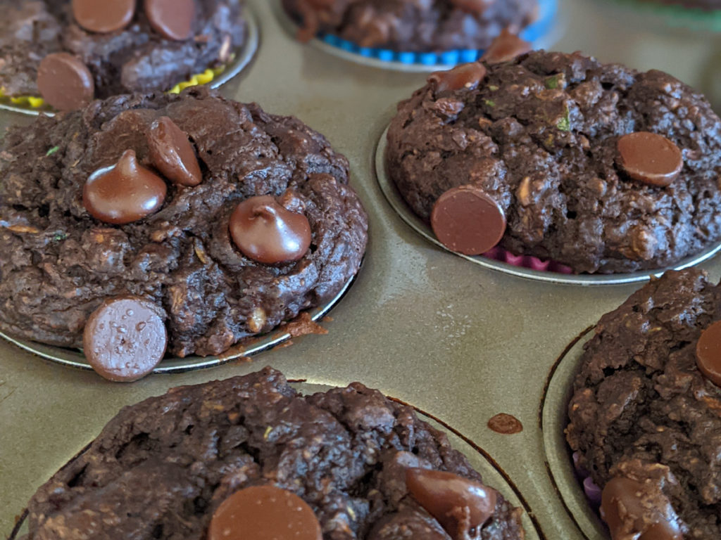 Chocolate Zucchini Muffins in a muffin tin.