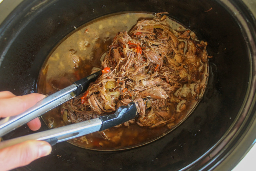 Shredded Italian Beef in a crock pot.