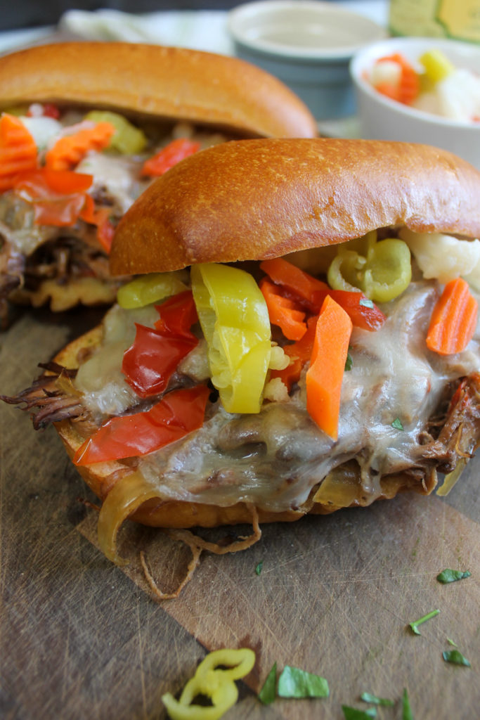 Italian Beef Sandwiches with Giardiniera on Hoagies with Provolone.