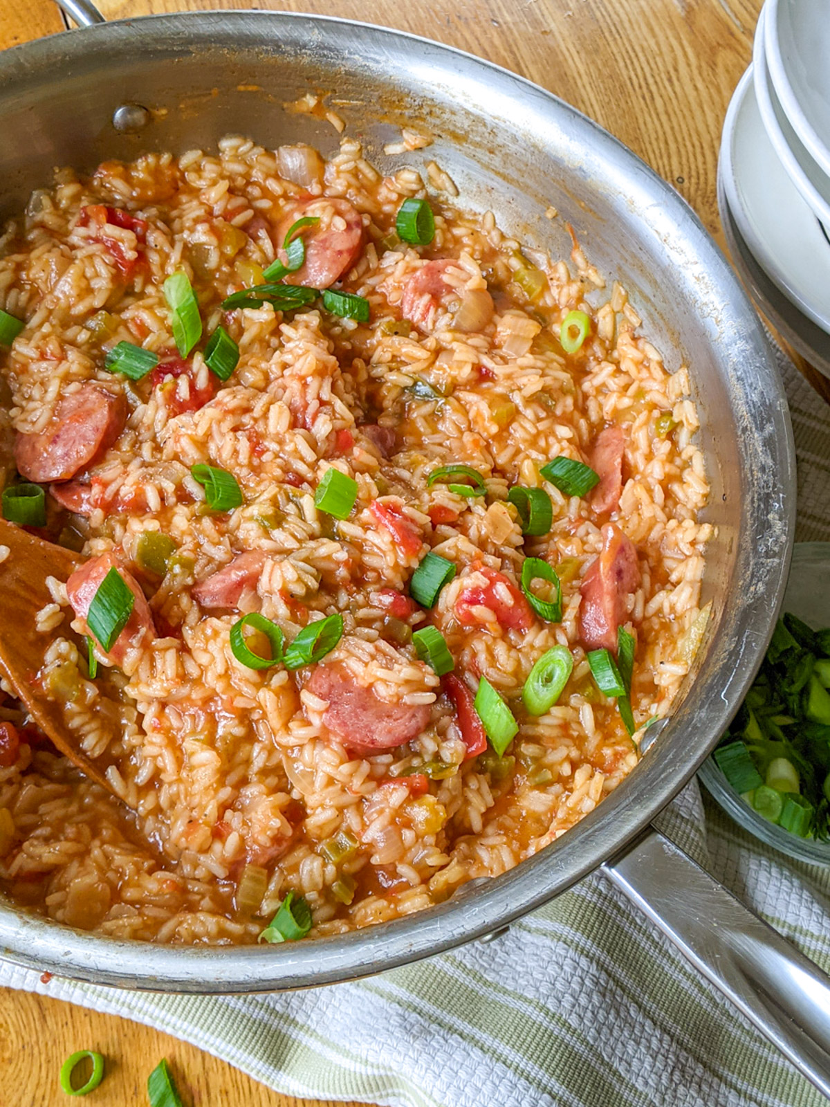A large skillet of One-Pot Jambalaya topped with scallions.