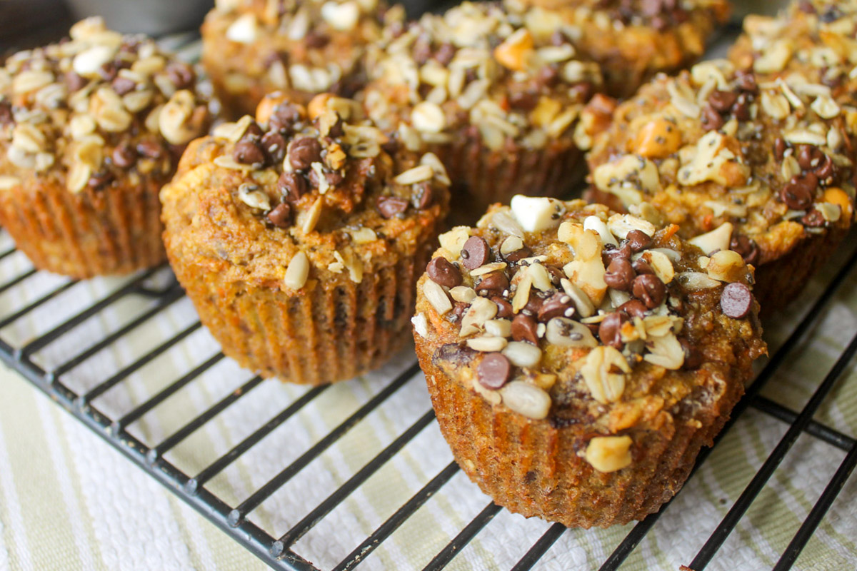 Morning glory muffins on a wire rack made with carrots, banana, apple, oats and nuts.