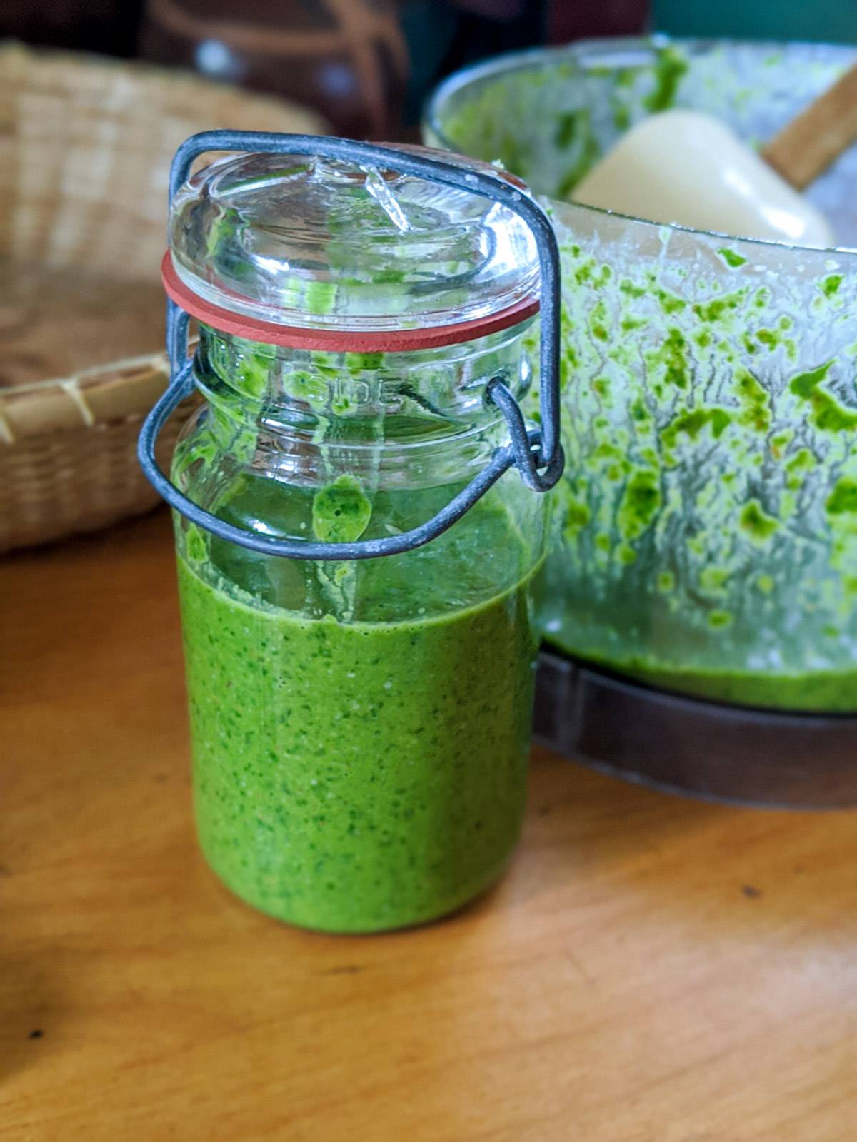 A jar of green homemade pesto to use for Alfredo pesto sauce.