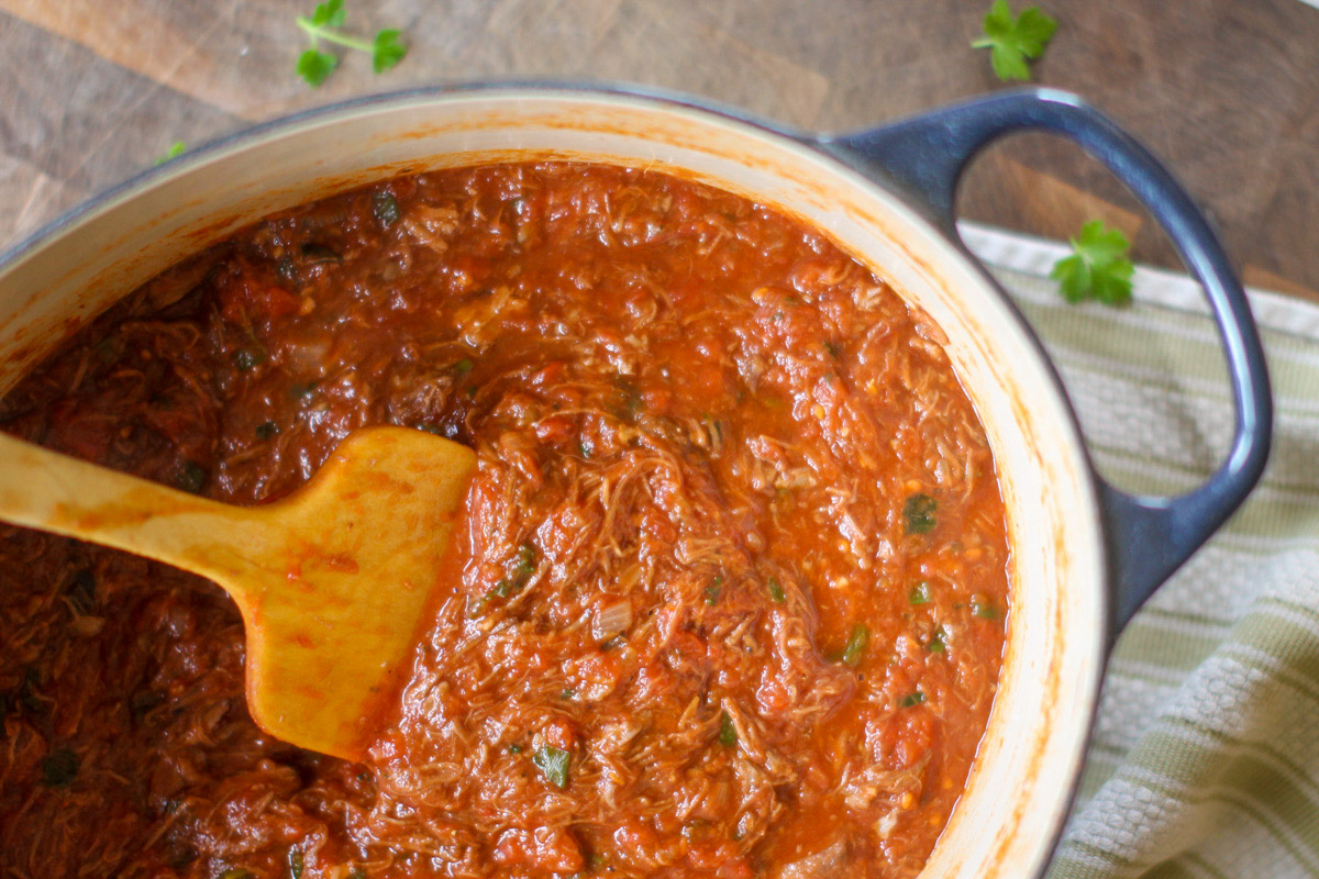 A blue pot of Ragu Sauce made from leftover beef roast and canned tomatoes.